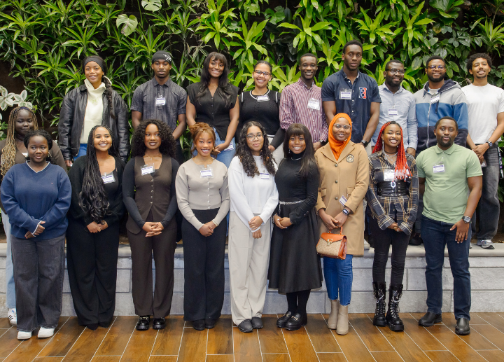 A group photo of Western BLUE students in front of a living green wall