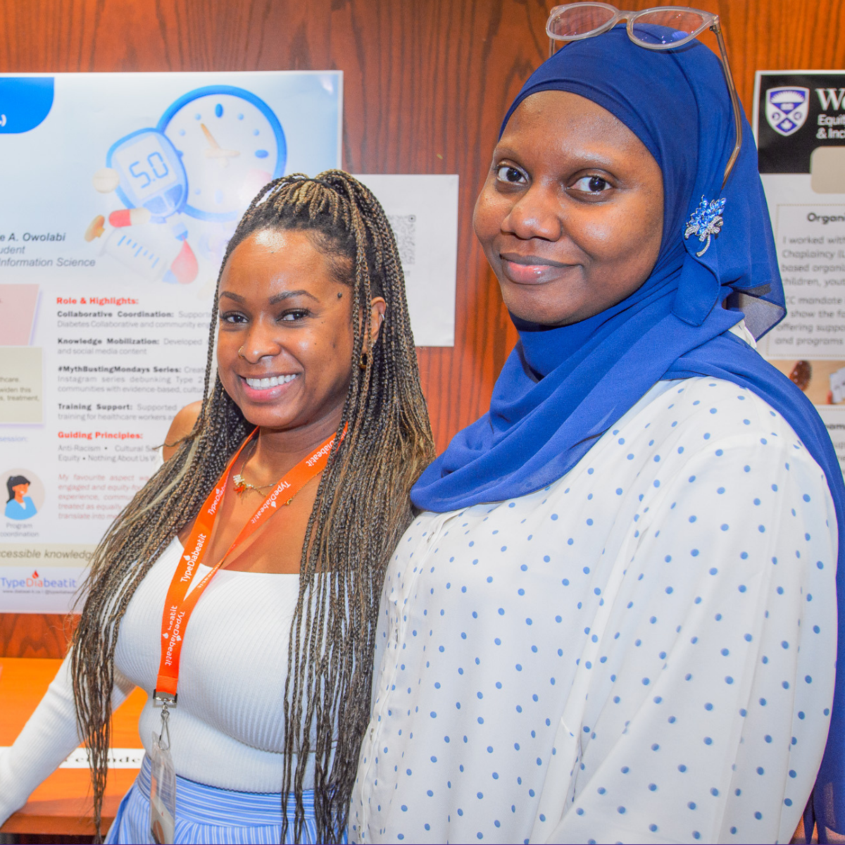 A photo of a Western BLUE student and a mentor standing in front of a poster at the Western BLUE Program Showcase in March 2026.