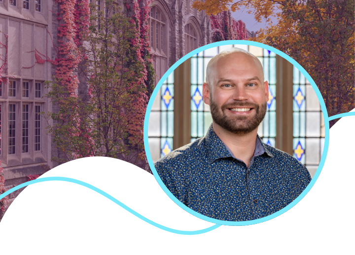 A photo of Michael smiling with a beard wearing a blue dress shirt