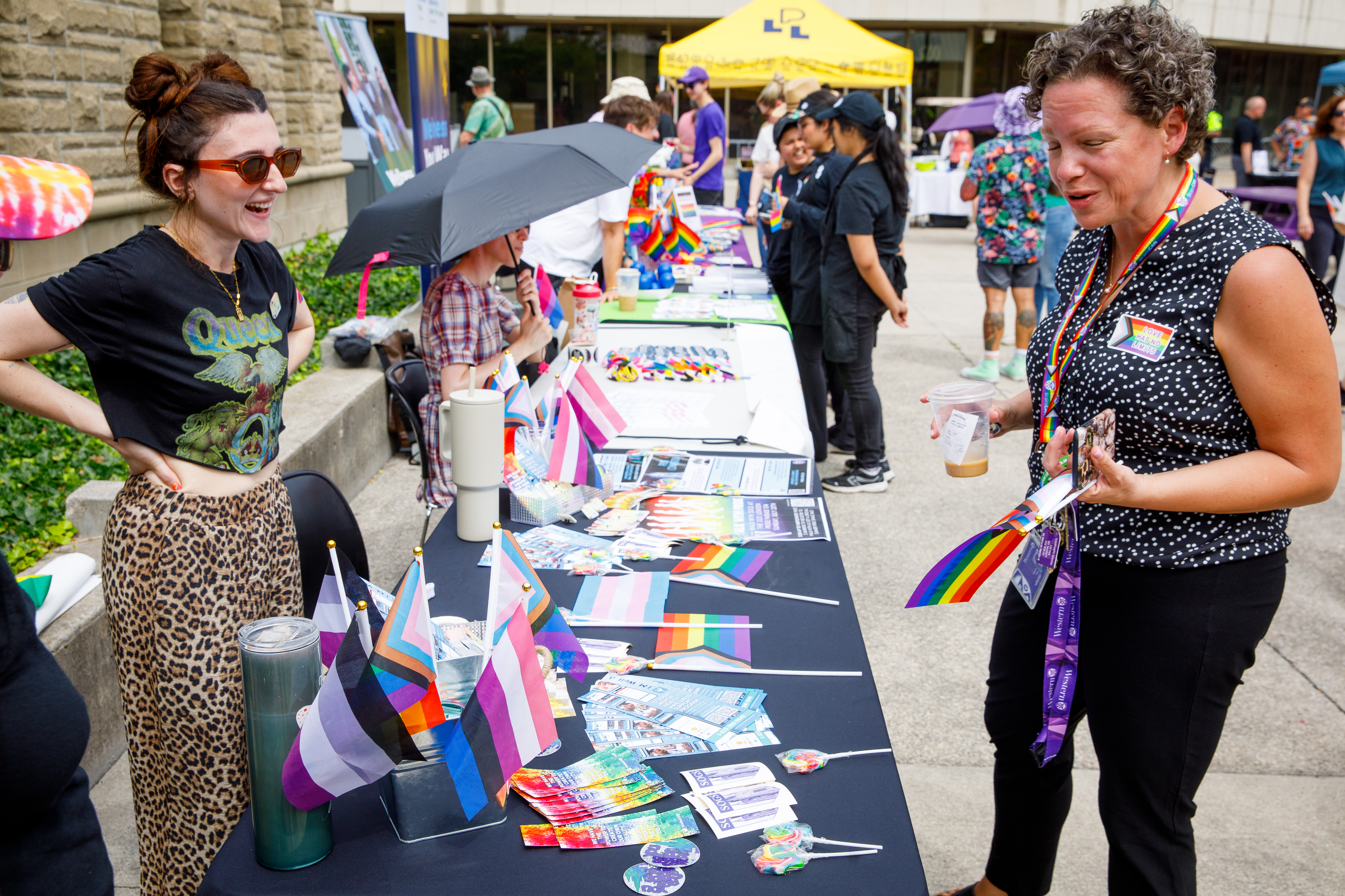 A woman with shares resources at a booth with another person.