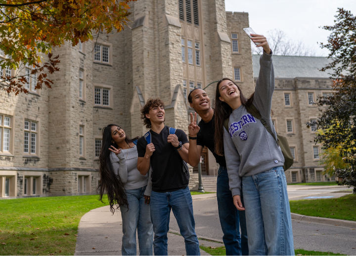 Four diverse photo pose while taking a selfie on campus