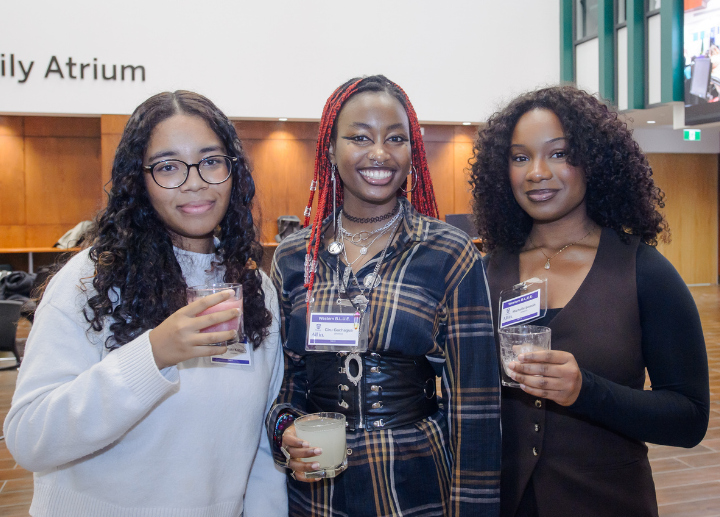 Three students pose for a picture at the Western B.L.U.E. Opening Celebration, holding drinks
