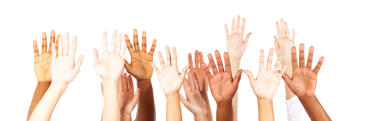 Raised hands in front of a white background